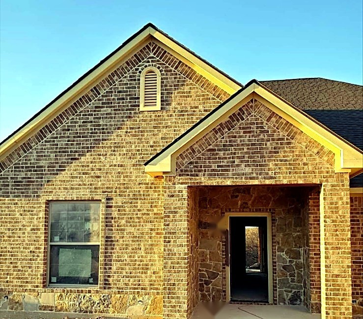 Brick and stone masonry around a home entry during construction