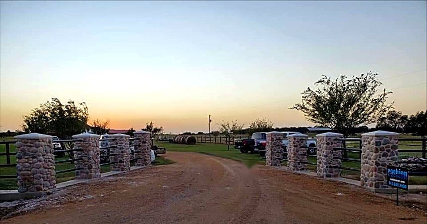 Natural stone ranch entrance columns at sunset