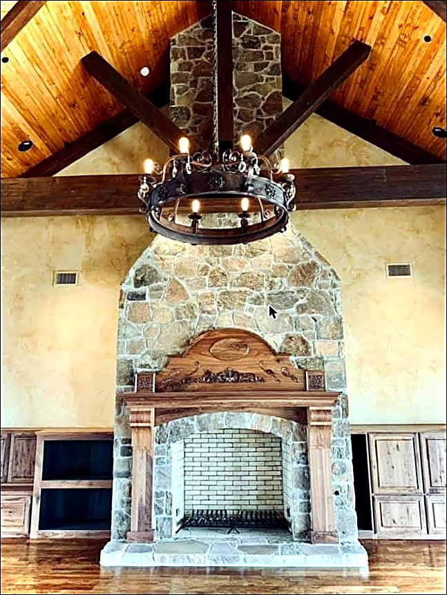 Floor-to-ceiling natural stone fireplace in a vaulted room