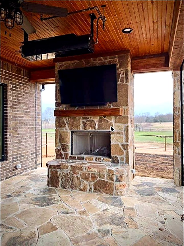 Outdoor natural-stone fireplace and flagstone patio built by Mendoza Masonry